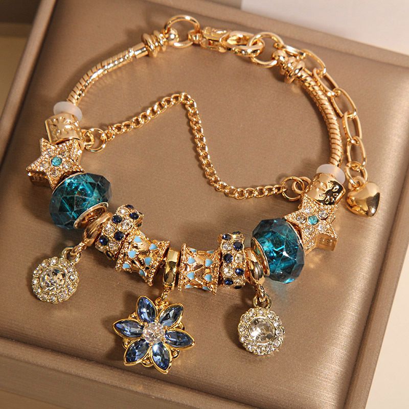 Luxury Gold-Tone Charm Bracelet with Blue Crystal Beads, Star & Flower Pendants, Sparkling Rhinestone Accents, Adjustable Design, Elegant Women’s Fashion Statement Jewelry
